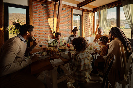 Ao fundo, imagem de uma família prestes a realizar uma refeição